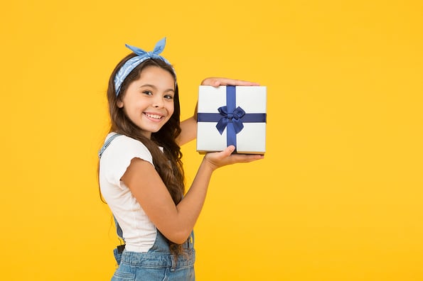 Child smiling happy hold gift box. Kid girl delighted gift. Unexpected surprise. Thank you. Celebrate birthday. Kid birthday gift. Extra bonus. Grateful for good gift. Surprise and present box.
