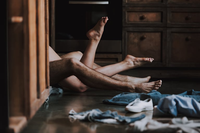 Attractive Passionate Couple Having Sex in Kitchen. Man and Woman Lying on the Floor in the Kitchen at Home and Having Sex. Love Concept. Romantic Date. Relationship. Husband and Wife.