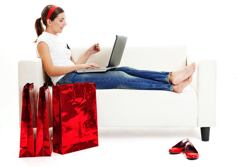 Beautiful young woman doing online shops with a credit card Consumerism concept