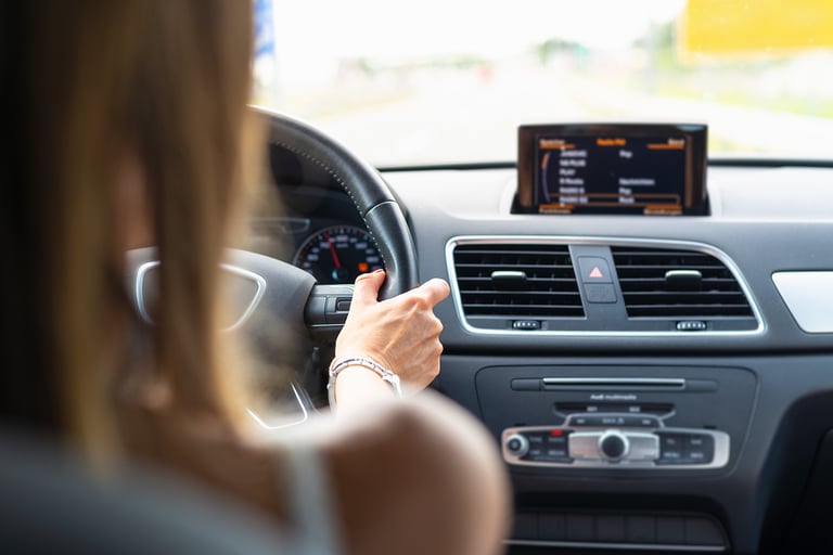 Woman driving car. Traveling by car on the road. Woman driving car in highway.Travel by car in highway. Car. Travel. Woman hand holding car steering wheel. Road trip traveling