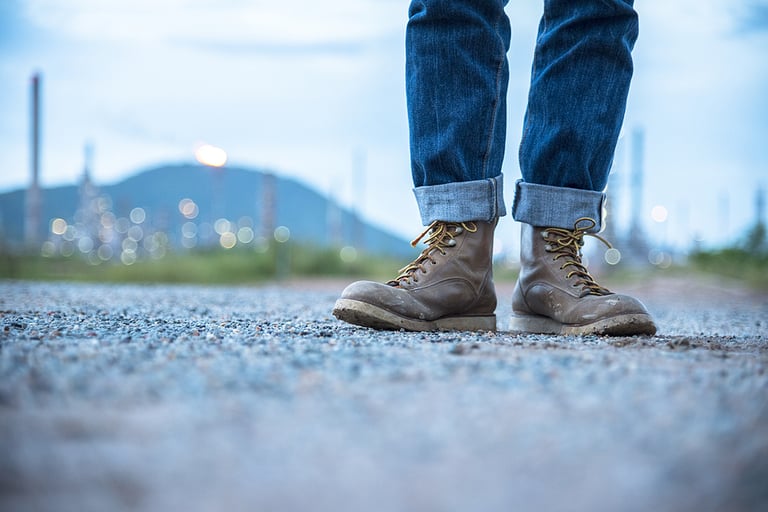 Boots safety worker at construction site. Engineer Wear Jeans And Brown Boots for Worker Security on Background of Refinery. Engineer safety industry fashion foot walking outdoor.