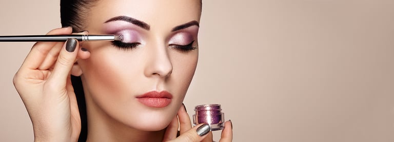 Makeup artist applies eye shadow. Beautiful woman face. Perfect makeup. Makeup detail. Beauty girl with perfect skin. Nails and manicure makeover