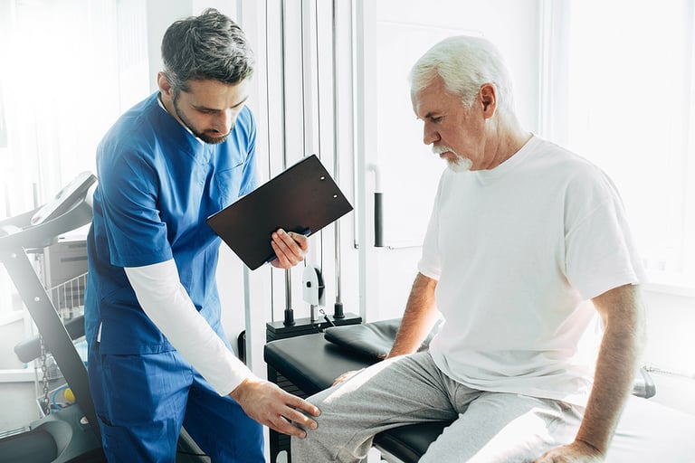 physiotherapist exam patients knee. Senior patient with knee injury visit his physiotherapist