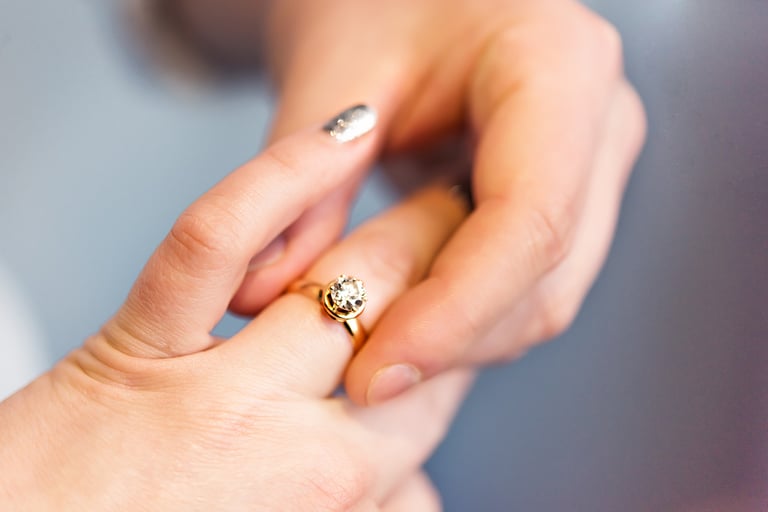 Groom put engagement ring on his bride finger. Jewellery diamond ring in husband to be hands. He put wedding ring on her finger. Wedding time. Happy engagement. Family and love. Man and woman hands