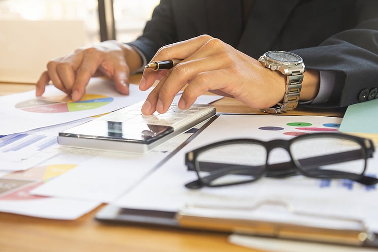 Business man in office and calculate financial plan sales. Working on desktop computer making business plan, business investment advisor consulting on the financial report, plan a marketing plan at business office. Business accounting plan concept.