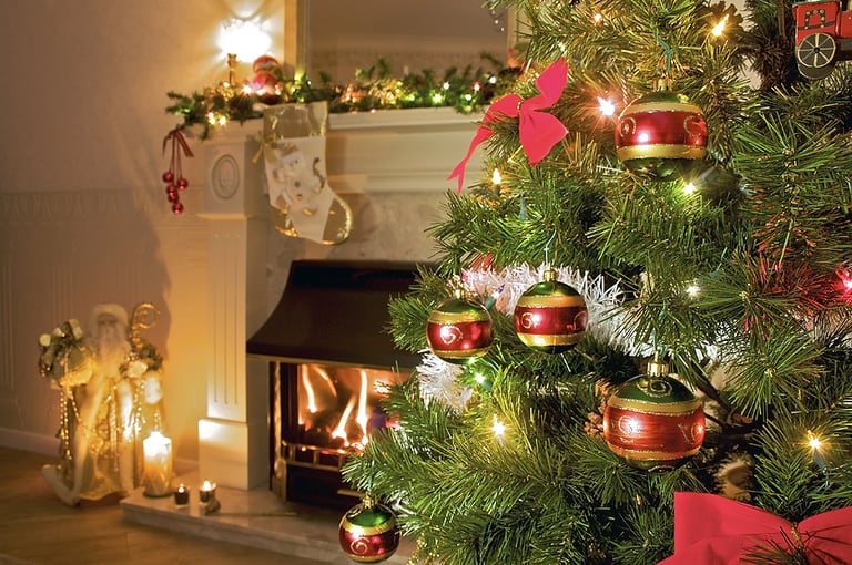 Christmas Decorating christmas tree in home living room with fireplace gifts