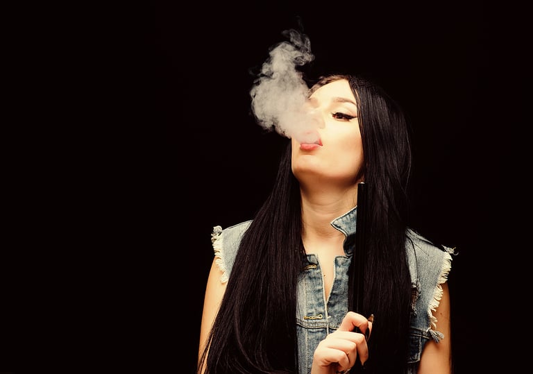 Girl vaping. Glamorous brunette smoking vaping device black background. Rest and relax. Hookah bar. Electronic cigarette. Fashion girl vaping. White cloud of smoke. Vaping is sexy. Nicotine addiction smoking