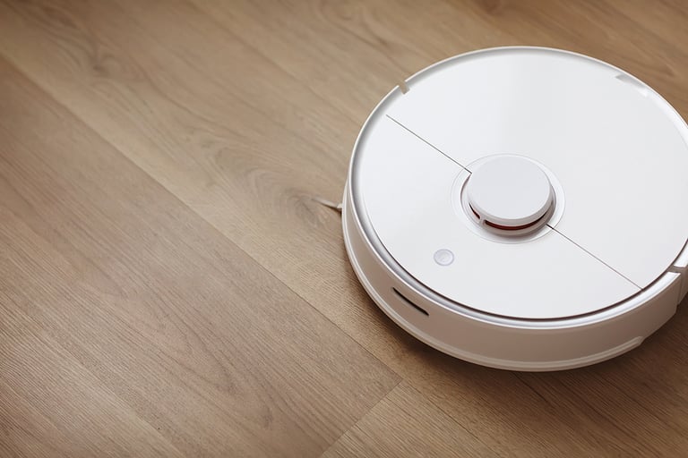 Robot vacuum cleaner performs automatic cleaning of the apartment at a certain time. white robot vacuum cleaner. home cleaning. Smart home. selective focus