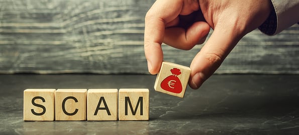 Businessman puts wooden blocks with the word Scam. Fraudulent investment project. Illegal plan to get money. Cheating people. Raw deal. Financial Pyramide. Hacker attack