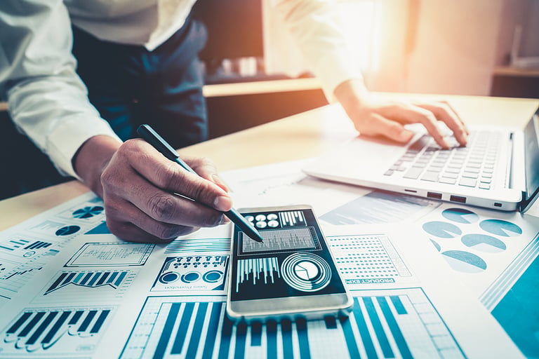 Businessman accountant or financial expert analyze business report graph and finance chart at corporate office. Concept of finance economy, banking business and stock market research.