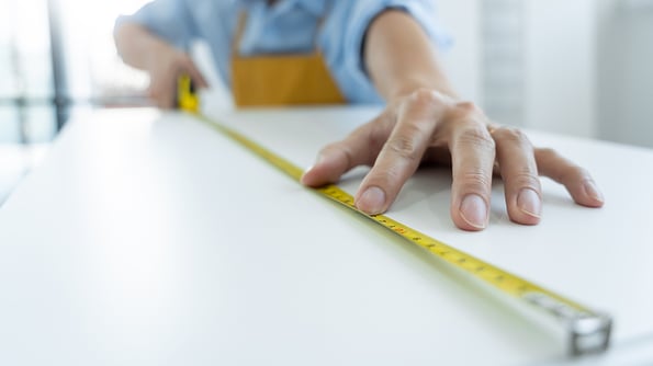 Men's hands hold a measuring tape measuring with flexible ruler for home renovation. repair, architecture and home renovation building and home concept