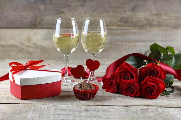 Valentine's Day concept Valentine's Day. Red rose with petals on a white background. Valentine's card, valentine's day, banners, postcard. Gift, roses and ribbon. Copyspace