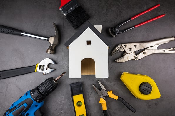 Wooden Model White Houses And Home Repair Hand Tools On A Cement Home Repair Hand Tools on a cement gray background. Concept home repair, Home improvement, Renovate home.Construction Tools Concept
