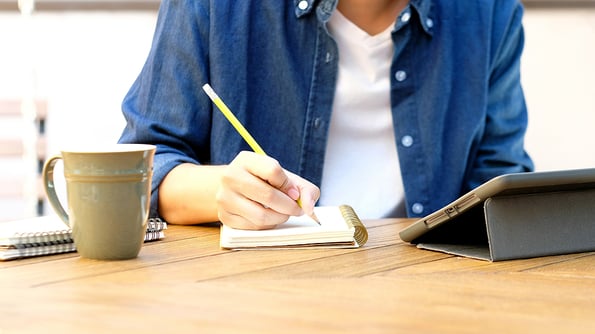 Online studying class, Student man hand writing on notebook while using digital tablet for e learning, Adult male university, college student study online course at home, education, Work from home