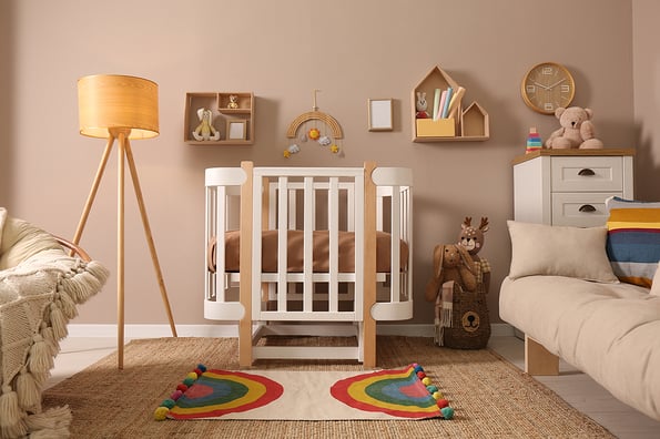 Baby room interior with stylish furniture and comfortable crib