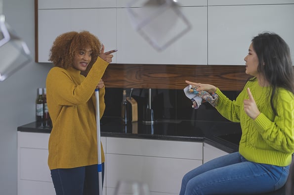Best friends roommates having fun while cleaning kitchen. Singing and dancing. Healthy relationship concept. High quality photo