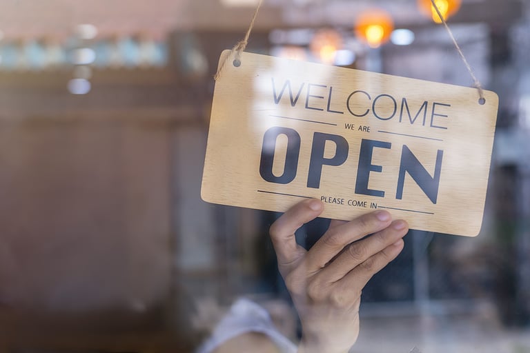 Hand of asian owner retail ,coffee shop woman turning sign board to open. Protection to pandemic of coronavirus. Open store,restaurant or pub due to lockdown quarantine of covid-19.