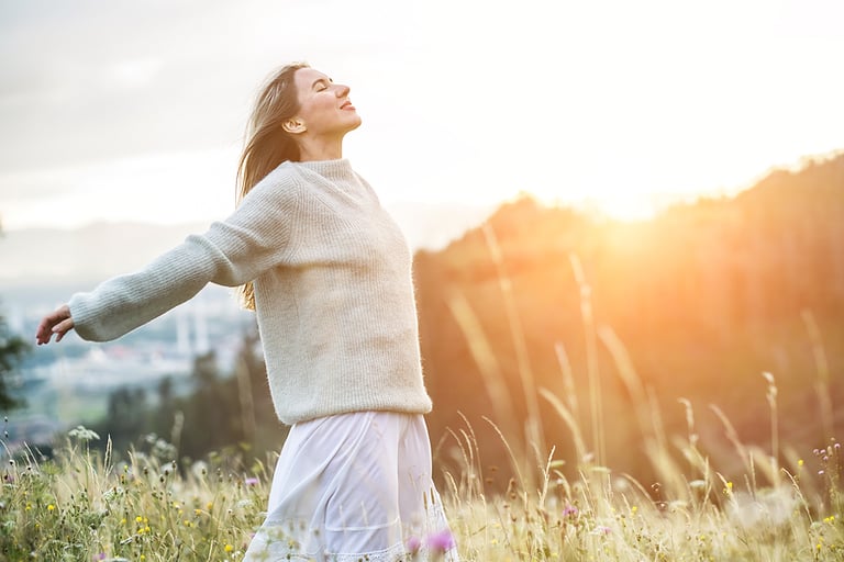 Portrait happy woman enjoying sunset stay on the green grass on the forest peak of mountain. Fresh air, Travel, Summer, Fall, Holidays, Journey, Trip, Lifestyle.