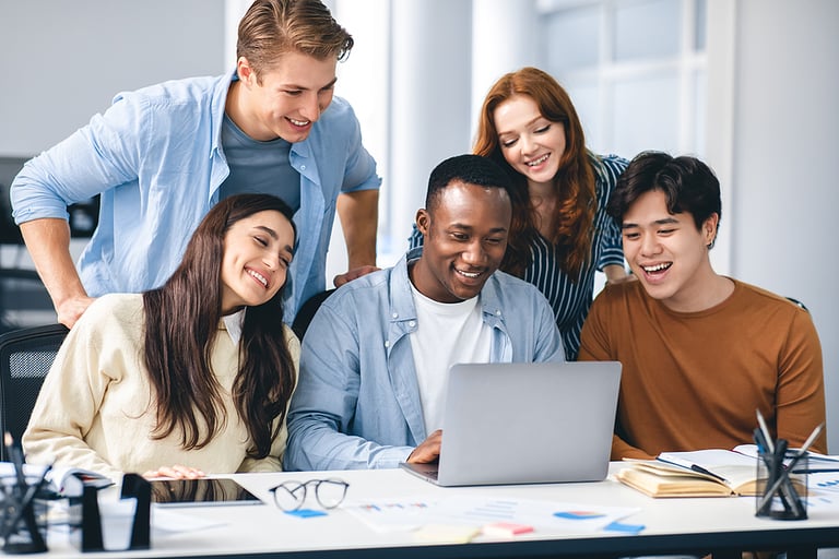Communication, Technology, Lifestyle And People Concept. Group of diverse international students or employees using laptop computers, studying and working, watching educational video, having fun