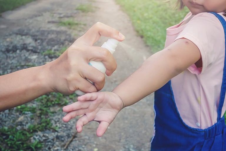 Hand spraying insect or mosquito repellents on skin girl, mosquito repellent for babies, toddlers that will protect your children from mosquitoes and other insects