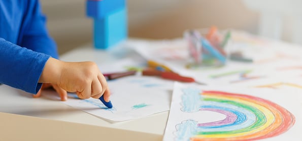 Kids paint. Quarantine fun. Child painting rainbow, sign of hope during coronavirus outbreak. Little boy drawing. School kid doing art homework. Arts and crafts for kids.No face