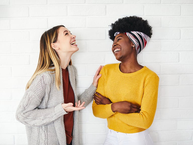 two young girls friend talking chatting and laughing