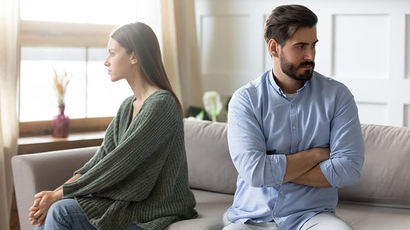 Unhappy couple sit separate avoid talking after fight