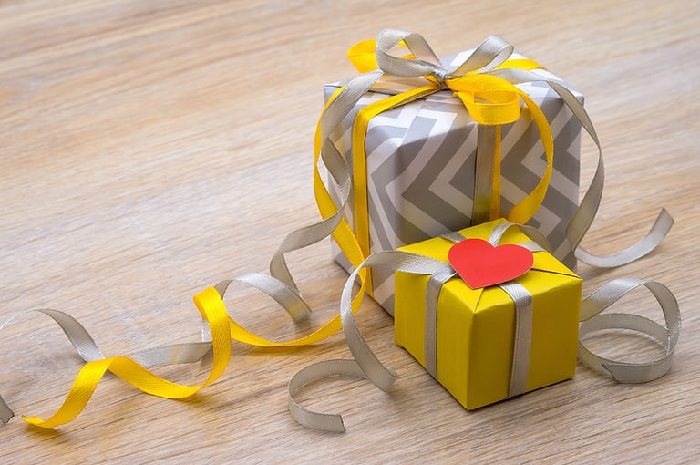 decor for valentine's day february 14, gray gift with yellow ribbon, birthday gift, congratulate on the holiday, give a gift, yellow-gray color in gifts, gift packaging with hearts, valentine's day