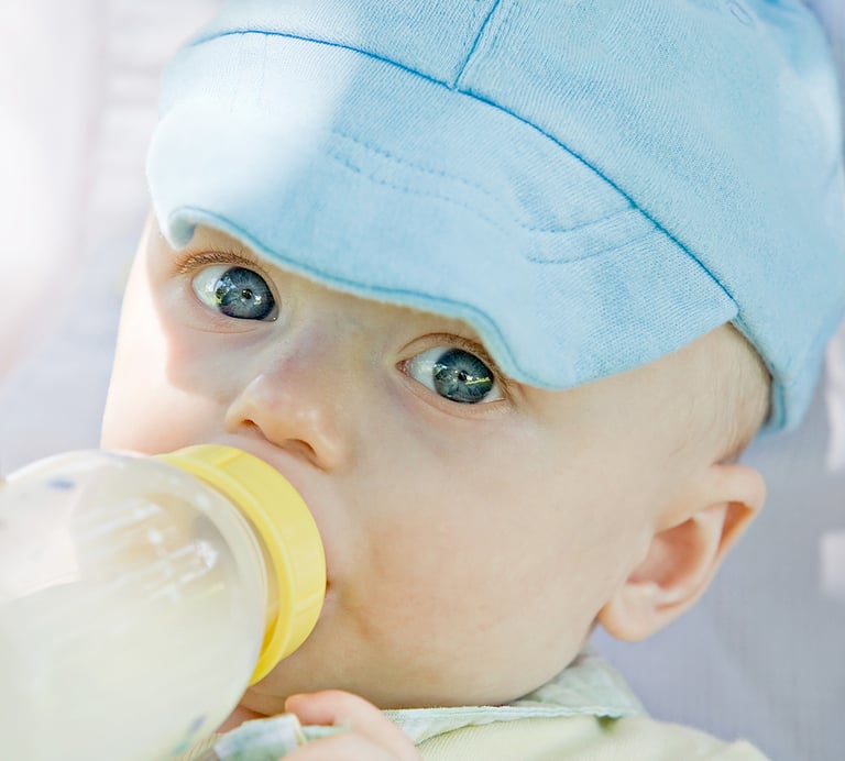 Infant Formula Little Baby Drinking out of a Bottle ** Note: Slight graininess, best at smaller sizes
