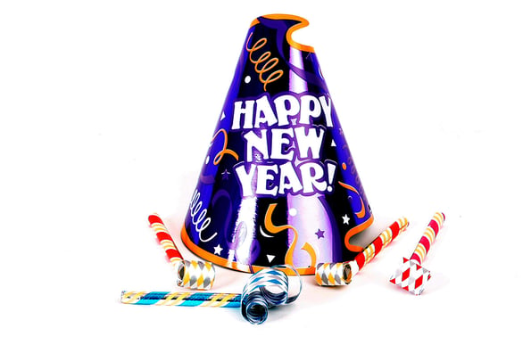 a happy new years hat with some noise makers on a white background
