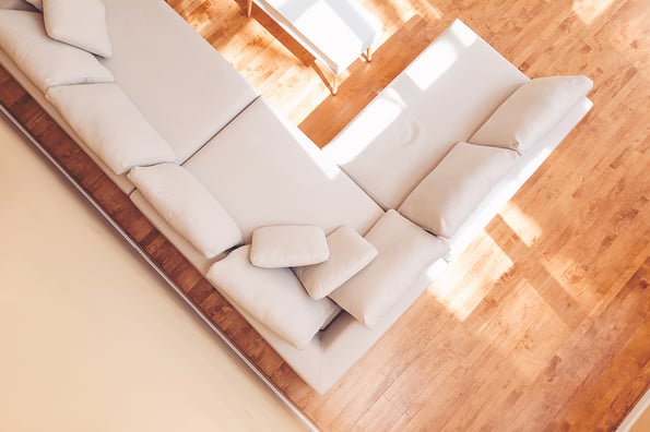 White sectional couch in a large luxury interior home
