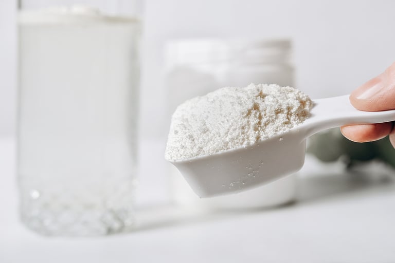 hand holding scoop of fish collagen. collagen peptides in container or jar. powder for mixing drink. Healthcare supplement concept. collagen for skin and joints