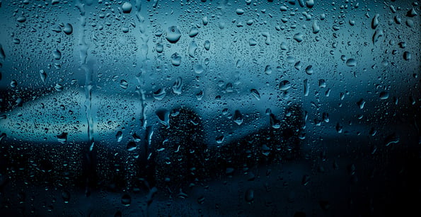 City view through a window on a rainy night,Rain drops on window with road light bokeh. Rainy days. Rain drops on window with street view ,rainy weather, rain background.