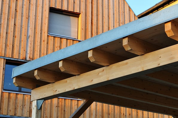 woodwork at the roof of a carport near residential building