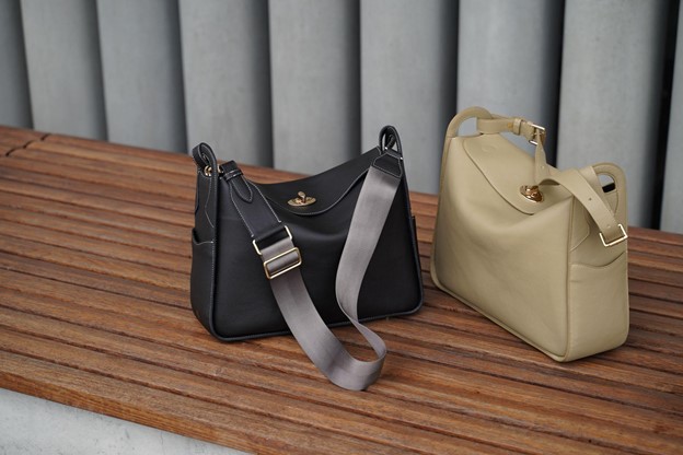 Black and beige black on a wood bench with grey background