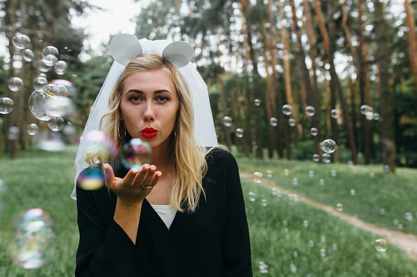 Bride making an air kiss on the hen party in the park in the background of the soap balls. Girl on the hen party