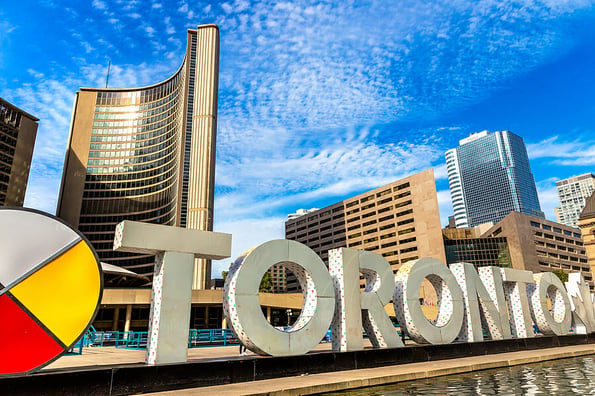 Toronto sign and city hall at Nathan Phillips Square in Toronto in a sunny day, Ontario, Canada