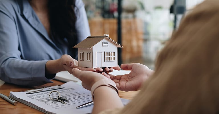 Real estate agent or sales manager offer home sale and explained the terms of signing the house purchase contract and free home insurance. Mortgage property insurance dream moving home concept.