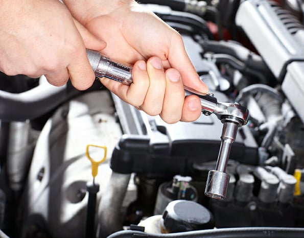 Hand with wrench. Mechanic. Auto repair shop.