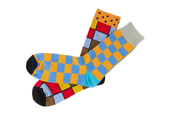 Pair socks with different lines isolated on white background. Colorful sock son white background. Colored socks on the leg isolated on white background