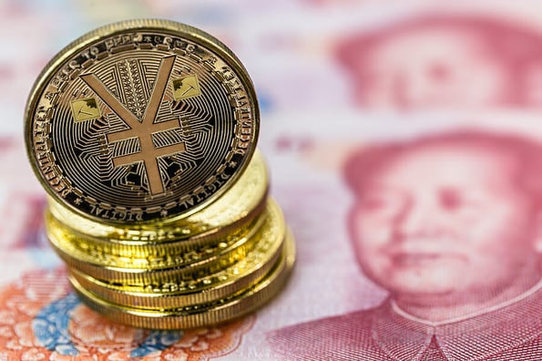 Chinese digital currency, conceptual image of the digital Yuan, or e-RMB, on old yuan banknotes