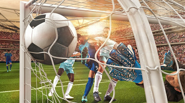Soccer action with the striker who scores a goal at the corner of the goalpost