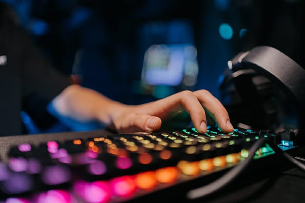 A professional e-sportsman plays games. Incognito Hacker. High quality photo