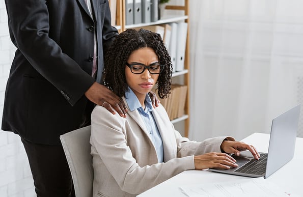 Sexual abuse at office concept. Male boss putting his hands on female employees shoulders, young woman feeling disgusted over molesting at workplace. Say no to harassment