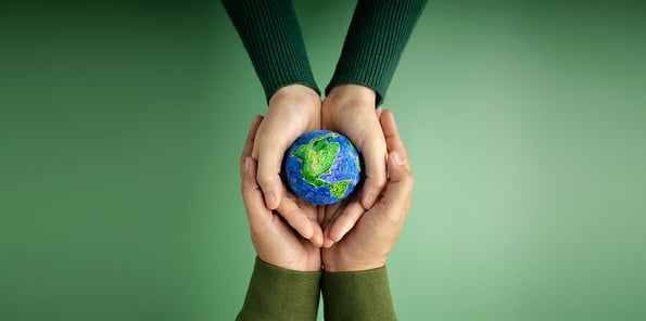World Earth Day Concept. Green Energy, ESG, Renewable and Sustainable Resources. Environmental Care. Hands of People Embracing a Handmade Globe. Protecting Planet Together. Top View