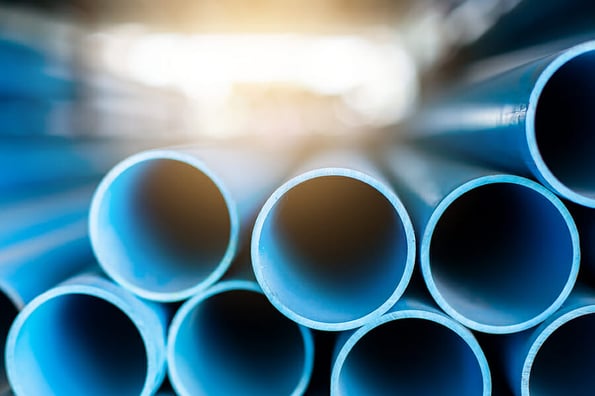 Close up to blue plastic pipe background, PVC pipes stacked in warehouse, PVC water pipes used for construction