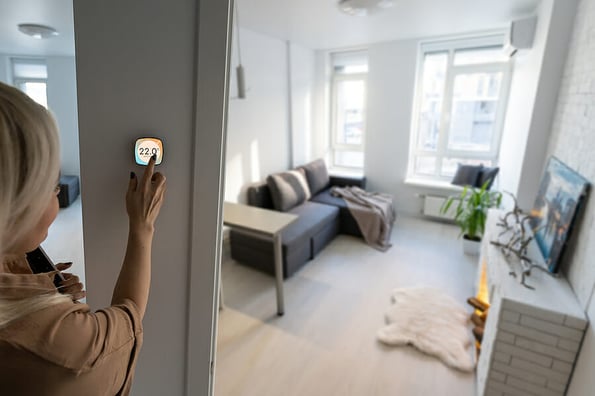 Controlling home heating temperature with a smart home, close-up on phone. Concept of a smart home and mobile application for managing smart devices at home