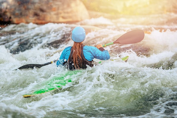 Young woman on kayak with spray paddle. Concept travel summer day