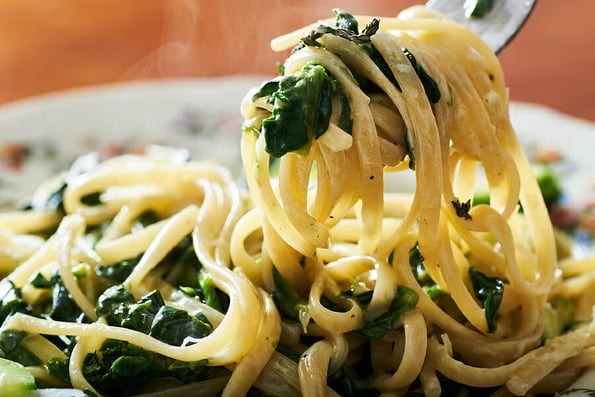 Spinach pasta food on plate.Spinach pasta food on plate.Italian spinach creamy pasta food. Pasta food. Vegetarian pasta food.Spinach tagliatelle pasta.Tagliatelle pasta Food. Creamy spinach pasta food on plate.
