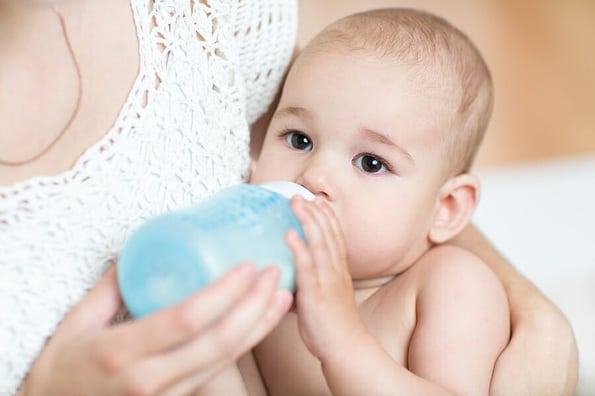 mother feeds baby boy milk from bottle ** Note: Shallow depth of field